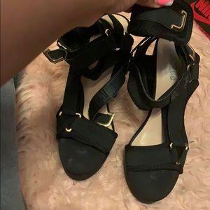 Black strappy black heels with gold buckles